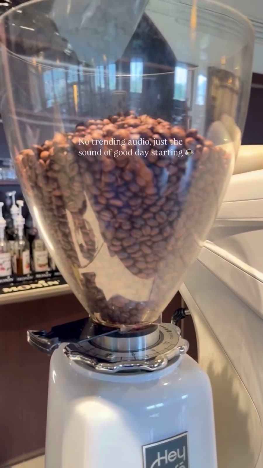 Coffee beans filling the hopper of the HeyCafé grinder