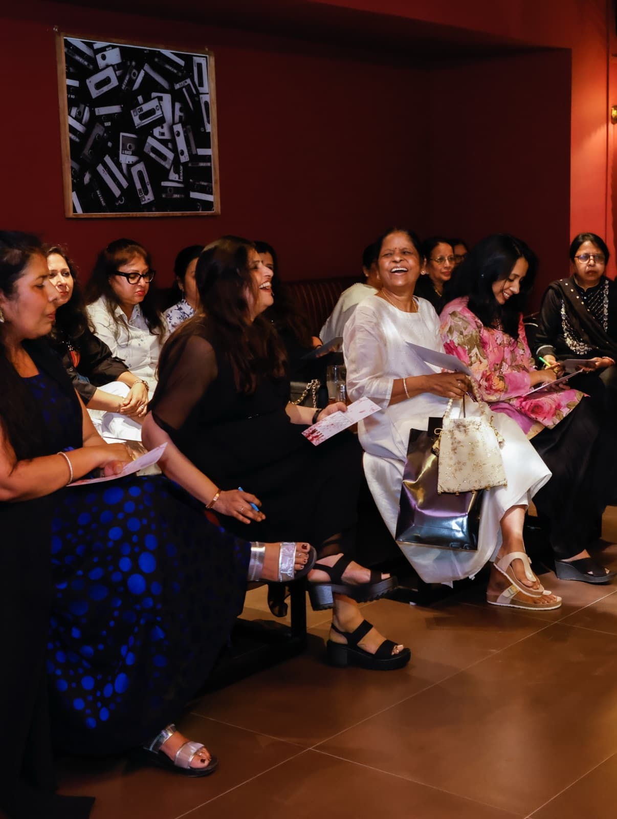 A group of women celebrating together on the maroon banquettes