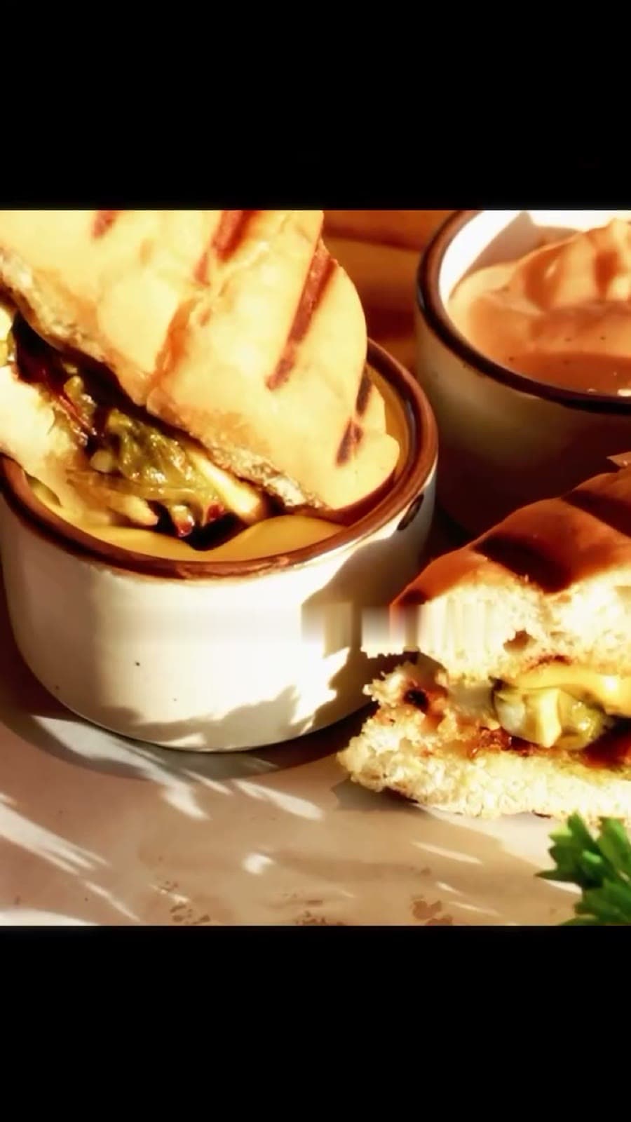 A grilled panini with a creamy dip
