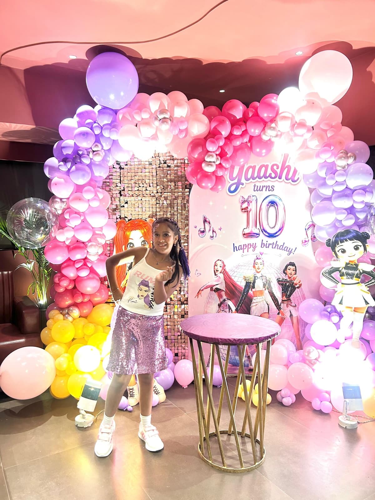 A pink and purple balloon arch for a kids' pop-themed birthday