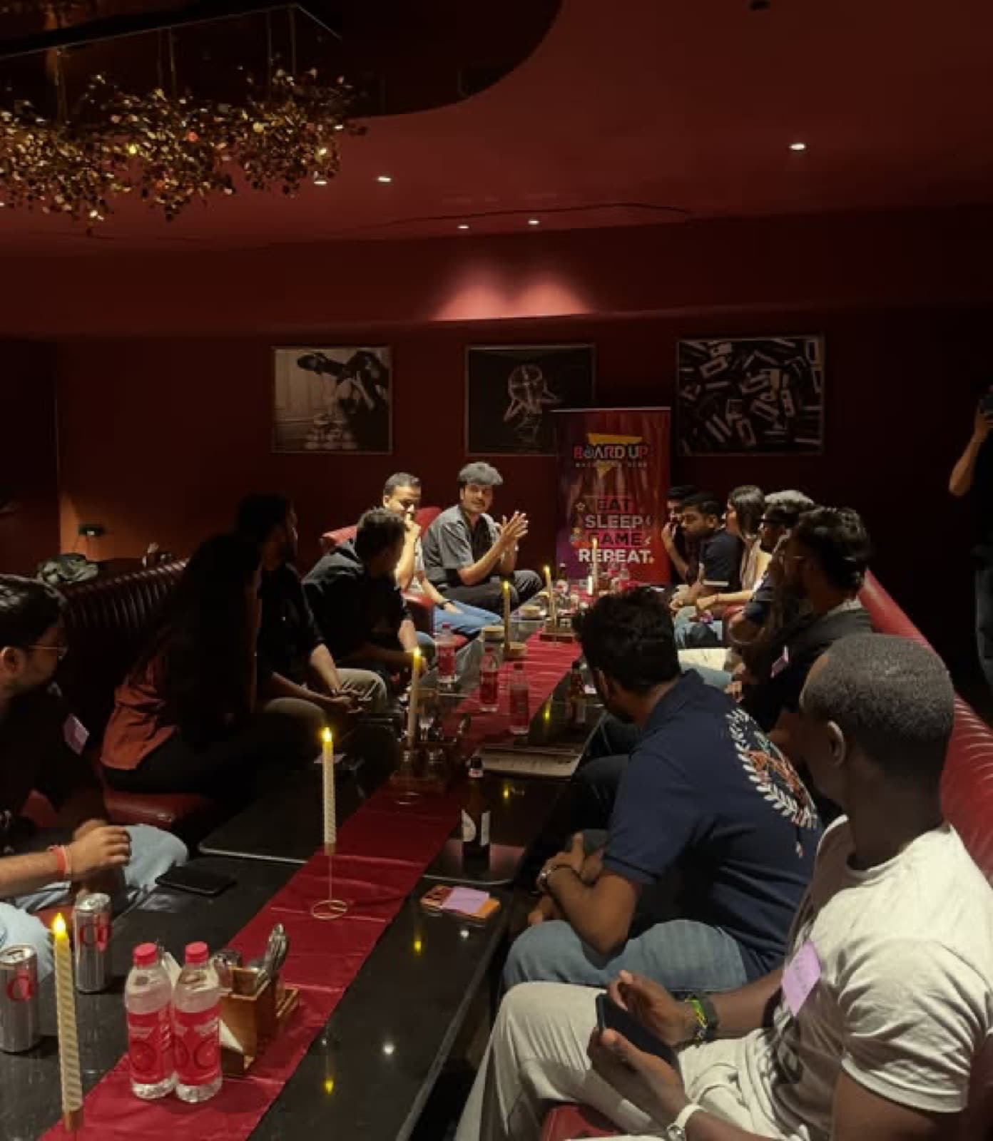 Friends around a candlelit table in the maroon Inner Circle lounge