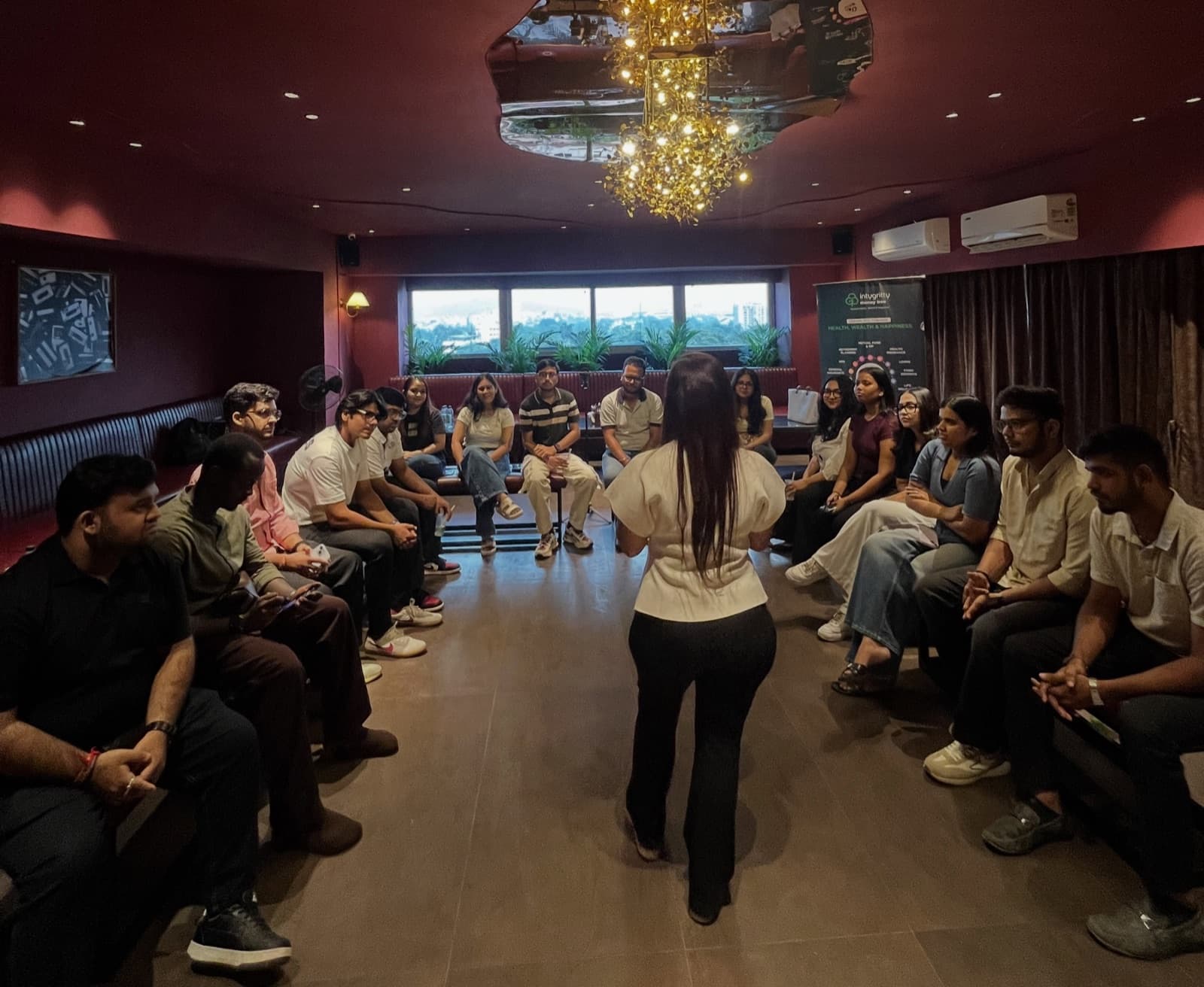 A community session in the Inner Circle room, guests seated in a circle