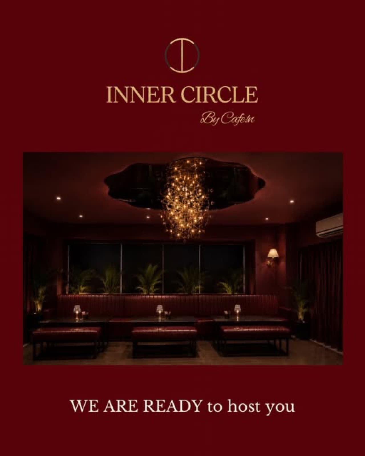 The Inner Circle private room with a crystal chandelier and maroon banquettes